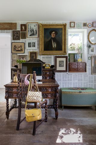 Hallway with a home office space, vintage furniture and gallery wall