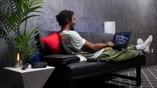 A man browsing JustGPU.com on a laptop