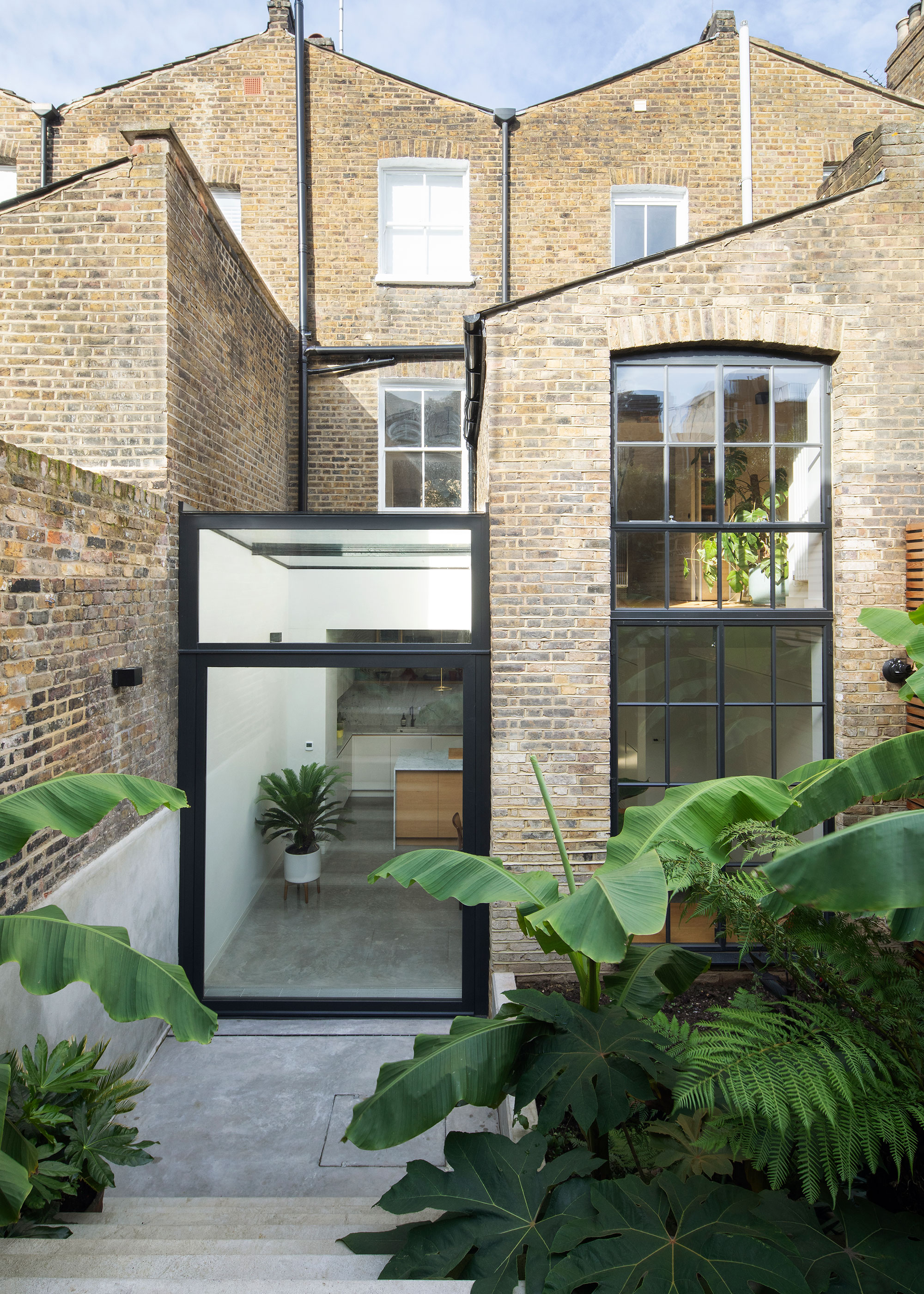 glass side extension to Victorian terraced house with full height glass