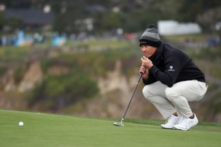 Collin Morikawa lines up a putt