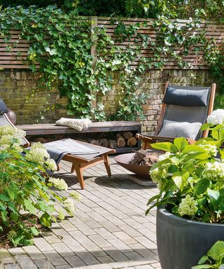 garden area with wooden fence and chairs