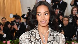 Solange Knowles wearing fall makeup looks, including a matte base and glossy lips