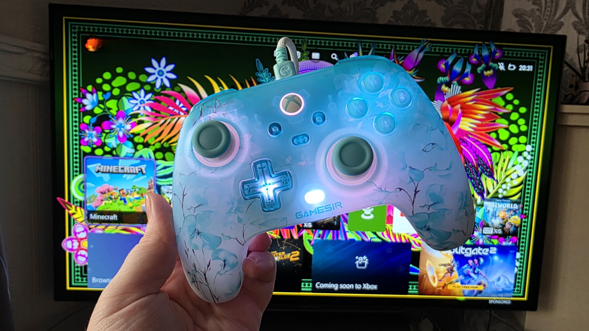A blue and white controller with floral pattern