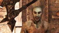 Dark Elf smiling at camera who looks like he's about to get hit by an axe