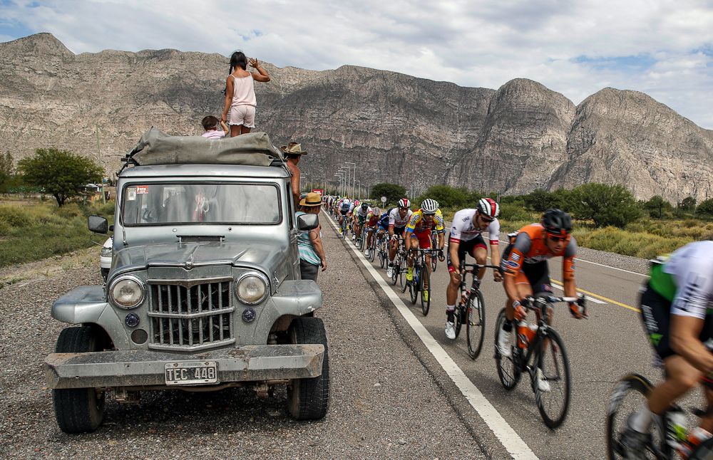 Spectators get a front-row seat as the Vuelta a San Juan peloton cruises by
