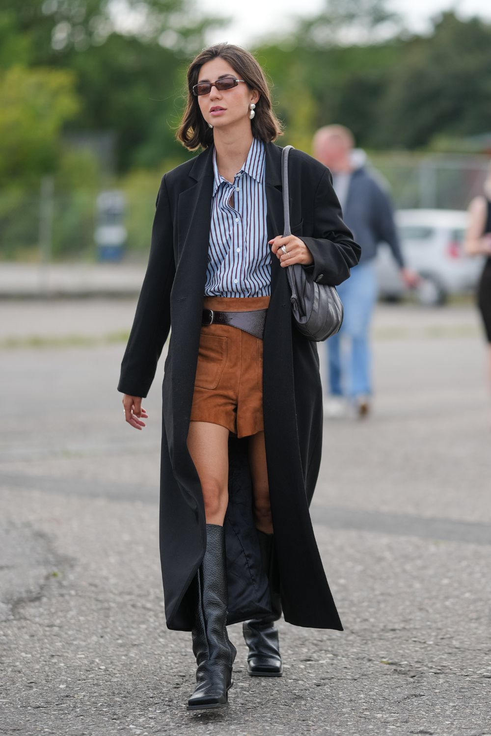 Shorts and boots outfit street styler wearing striped shirt, suede shorts and knee-high boots