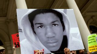 A protest showing a picture of Trayvon Martin recorded in the docuseries Rest in Power: The Trayvon Martin story.