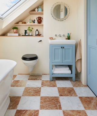 orange red marble and white checkerboard bathroom floor with a small bath sink vanity and vintage mirror