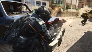 A soldier in black tactical gear fires red assault rifle