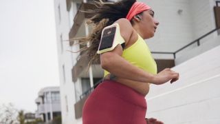 a photo of a woman running using the Peloton app