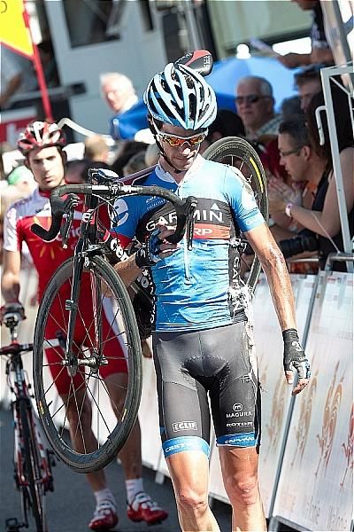 A battered Michel Kreder (Garmin - Sharp) walks to the finish line following a crash 100m from the end.