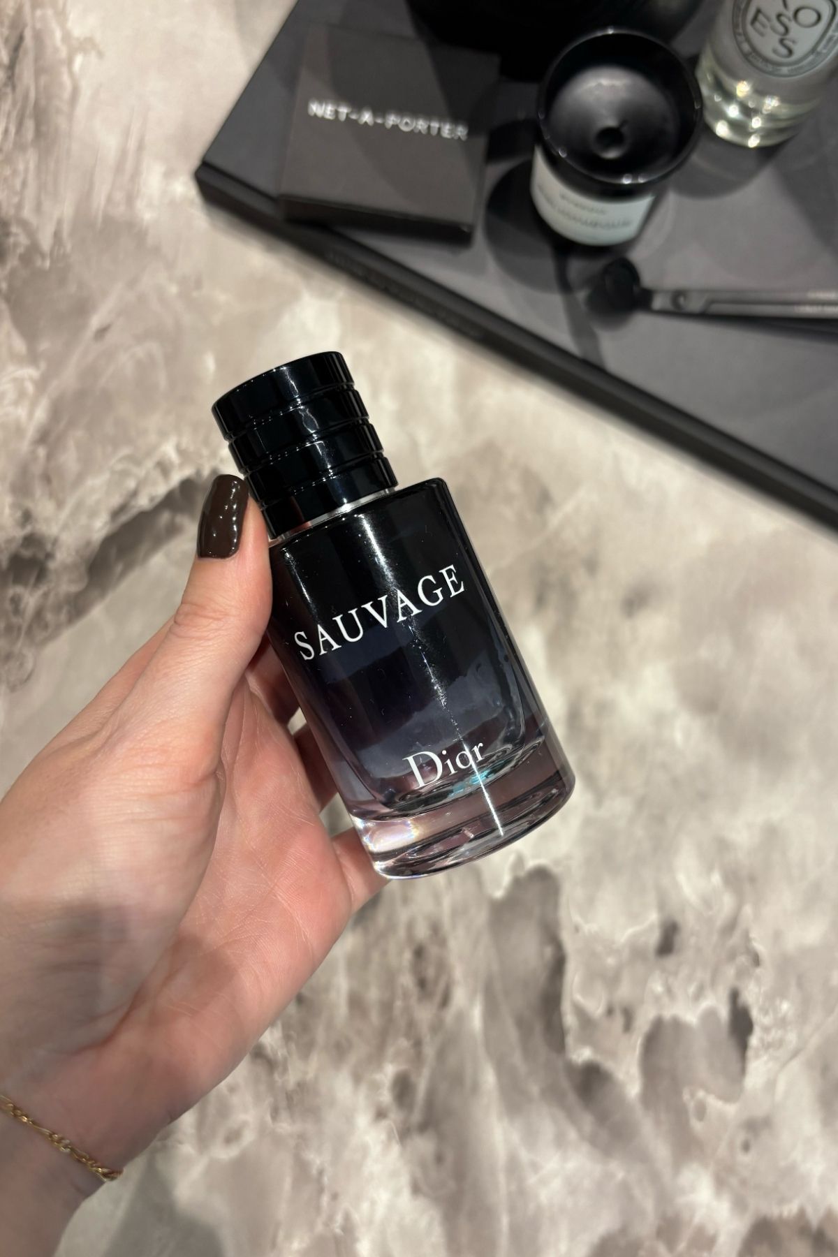 Deputy beauty editor Grace Lindsay holding a bottle of Dior Sauvage