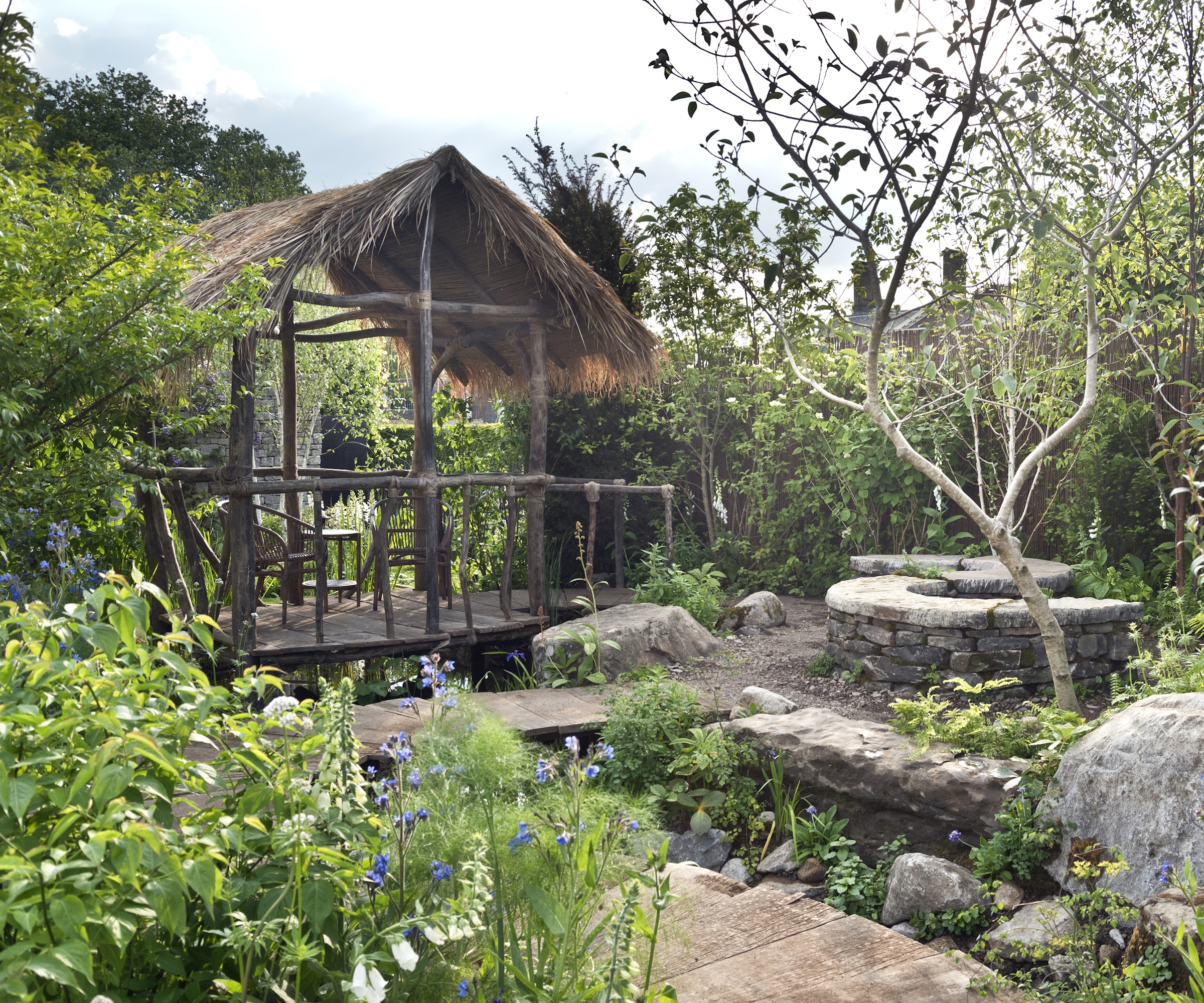 Rustic wooden structure in a wild garden with stone path