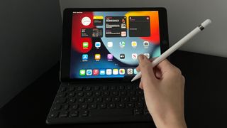The Apple iPad 10.2 (2021) being used with an Apple Pencil and a smart keyboard indoors