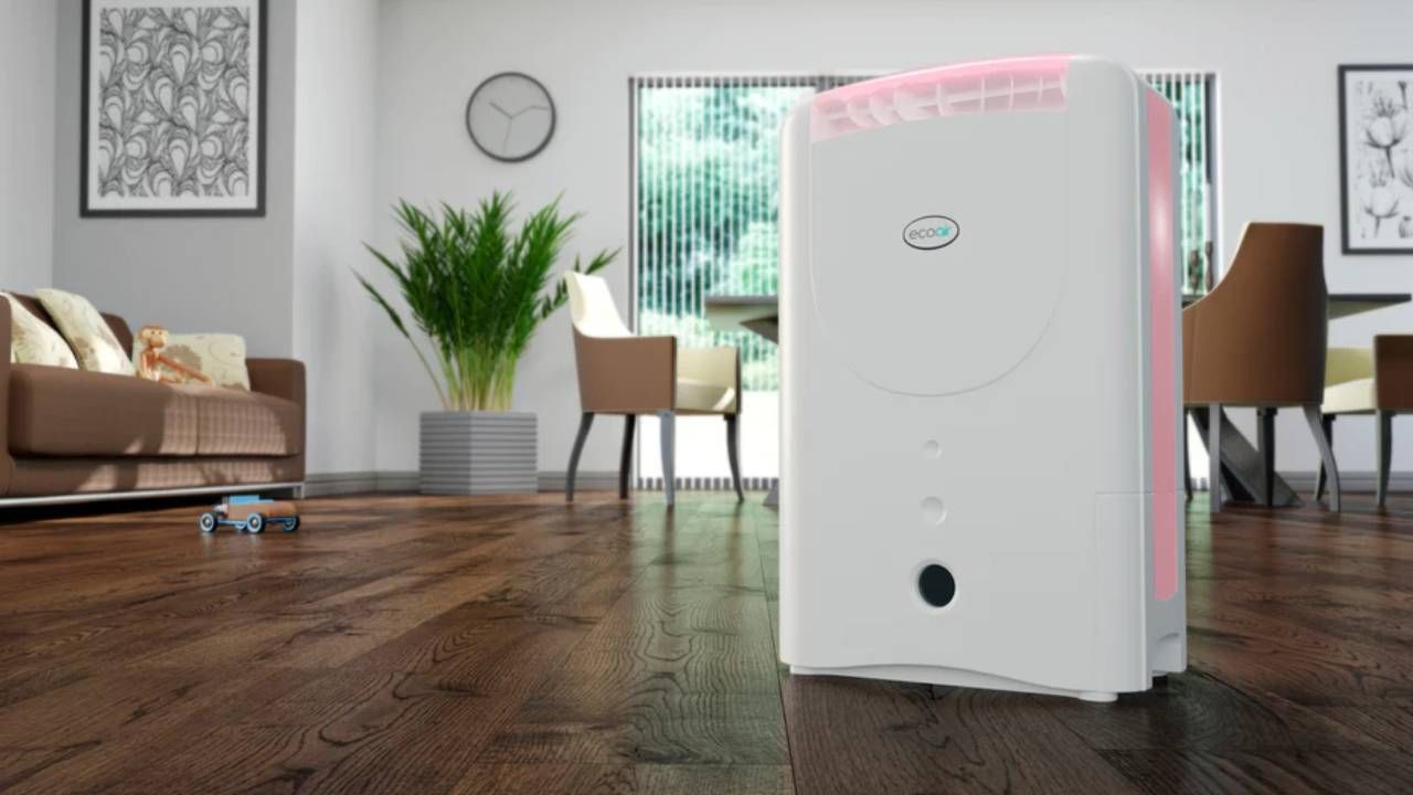 A closeup of an Ecoair dehumidifier sitting in a living room