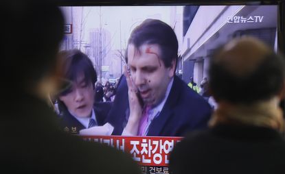 South Koreans watch the aftermath of the attack on Ambassador Lippert. 