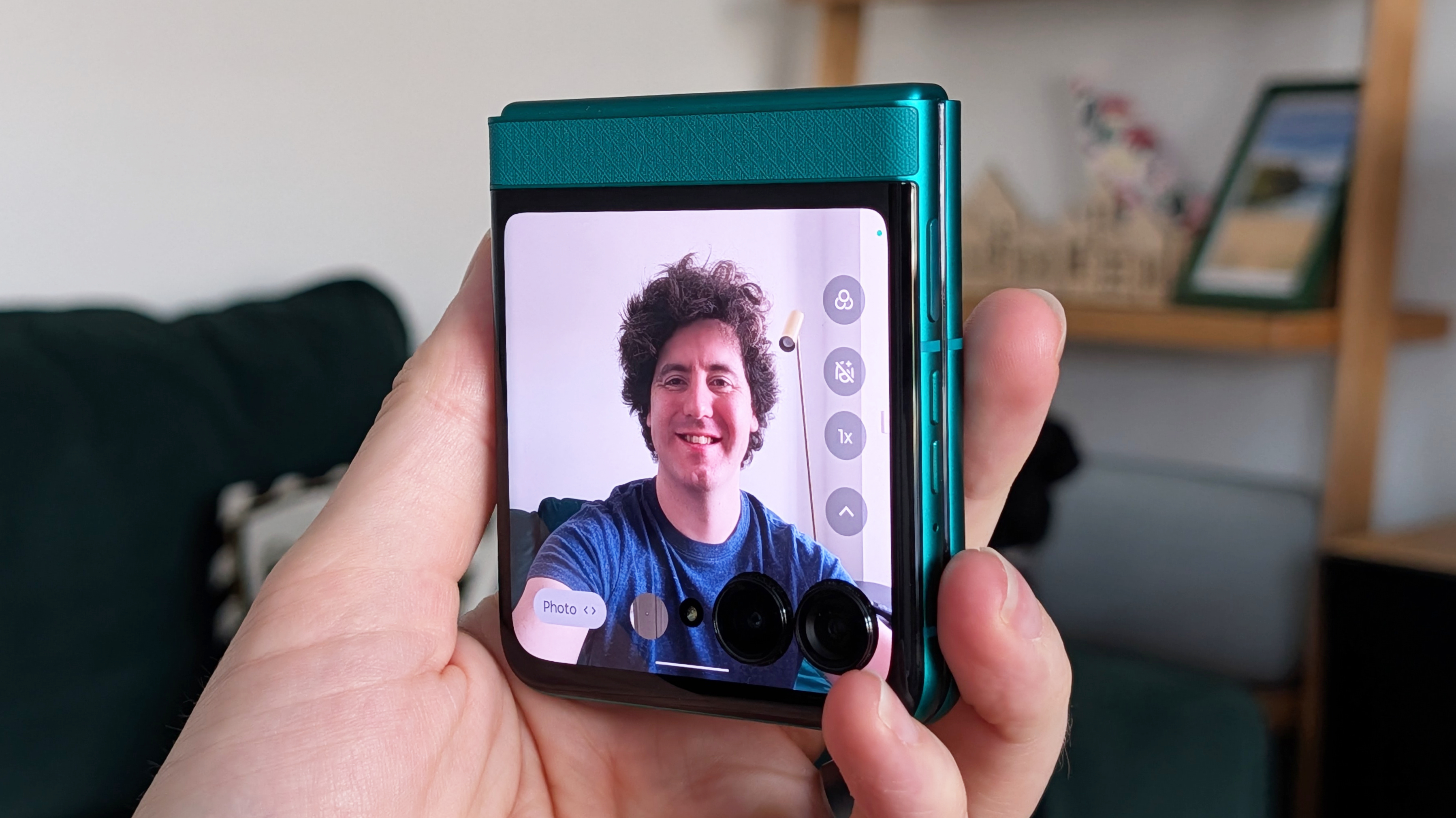 Motorola Razr 2026 in blue, being held in the hand