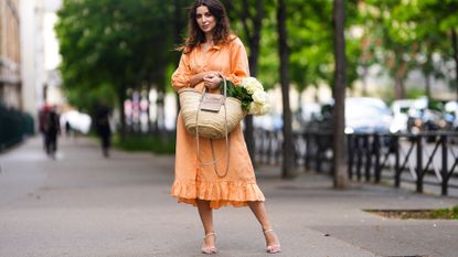 woman in orange dress and white strappy heeled sandals, white sandals