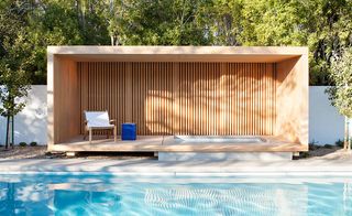 An open wooden cabana houses a jacuzzi and offers respite from the sun