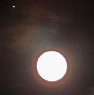 Astrophotographer Victor Rogus intentionally over-exposed this image of the moon and Jupiter in conjunction to capture three of Jupiter's Galilean Moons. He zoomed in using a Baader Planetarium Vario-finder (61mm x 250mm) as a lens at f4.1 exposure time, 0"4 of a second and ISO at 200.