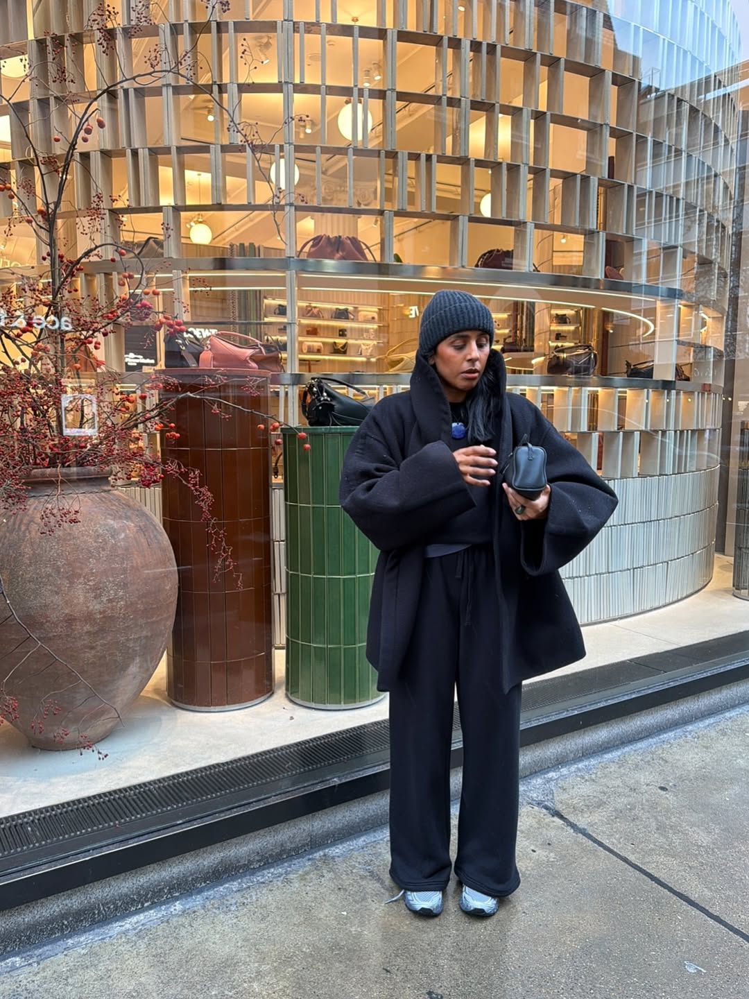 Monikh wearing track pants with a cocoon coat.