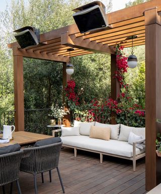 decked patio with timber pergola and seating area