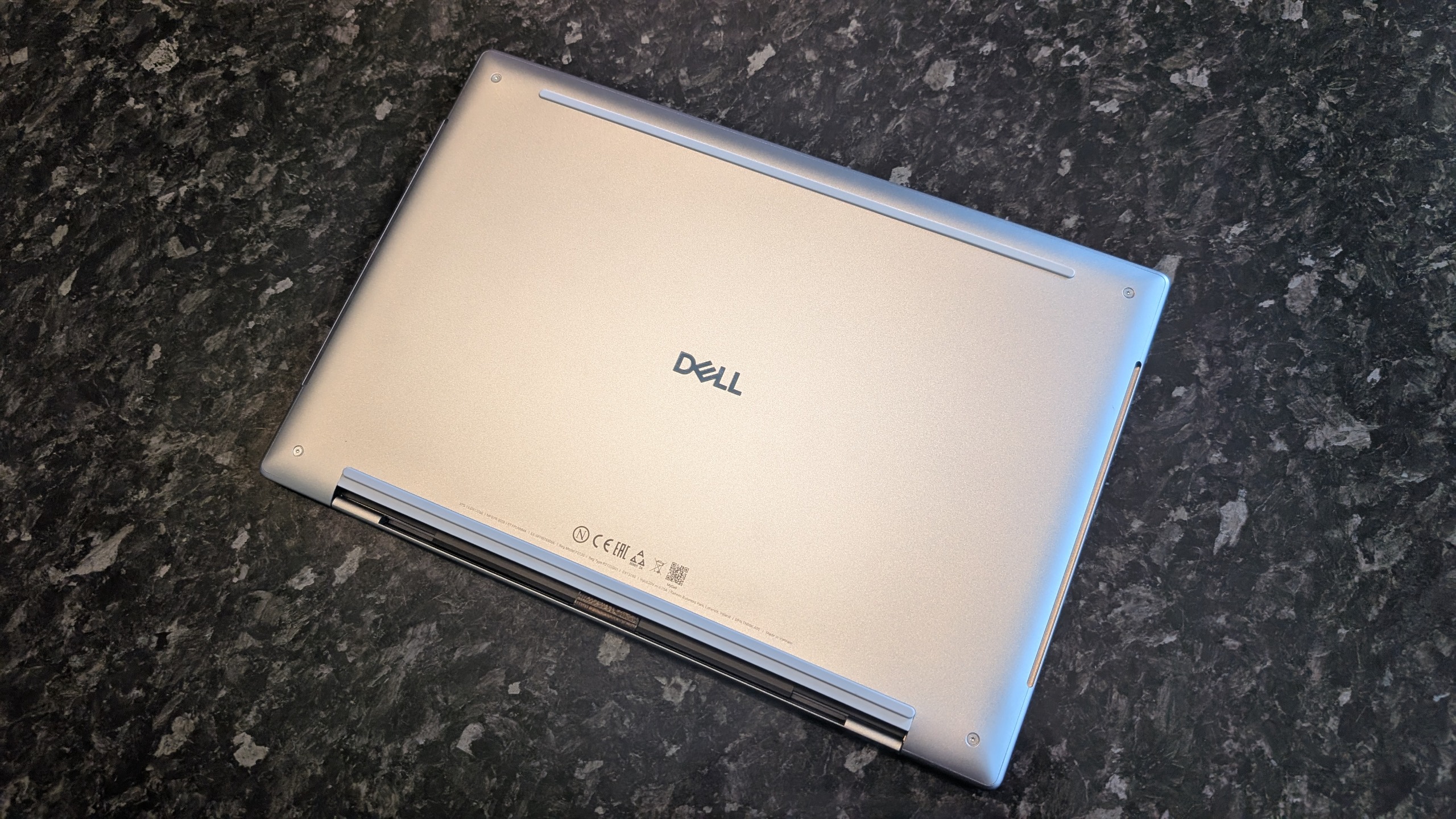 The Dell XPS 13 (2026) laptop pictured on a black marble worktop.