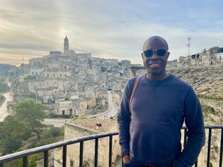Clive Myrie’s Italian Road Trip - Clive Myrie standing in front of a pretty Italian backdrop