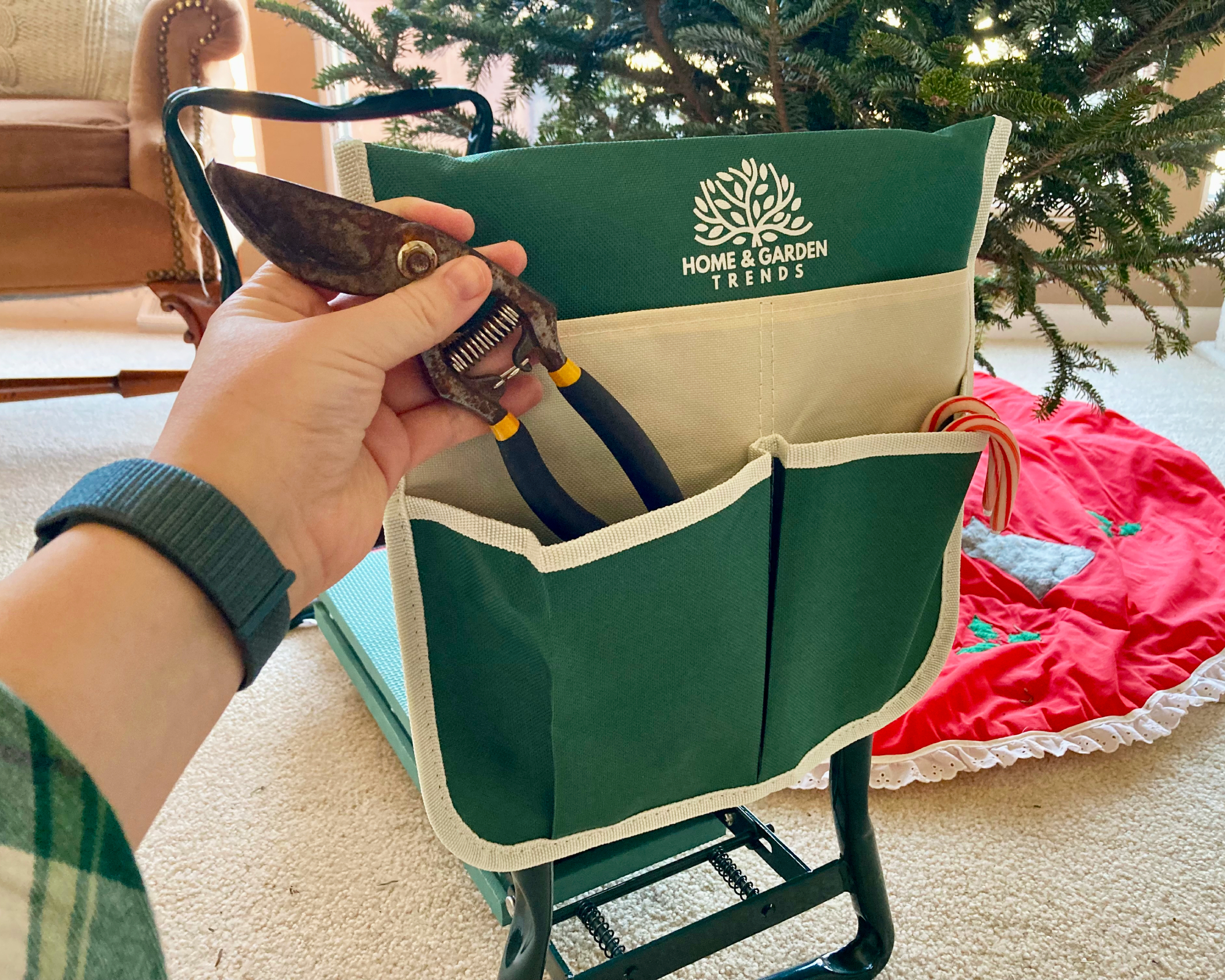 Laura Walters putting pruners in holder on kneeler