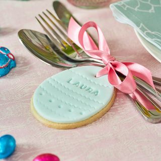 Personalised biscuit used on place setting on a pretty and colourful easter table
