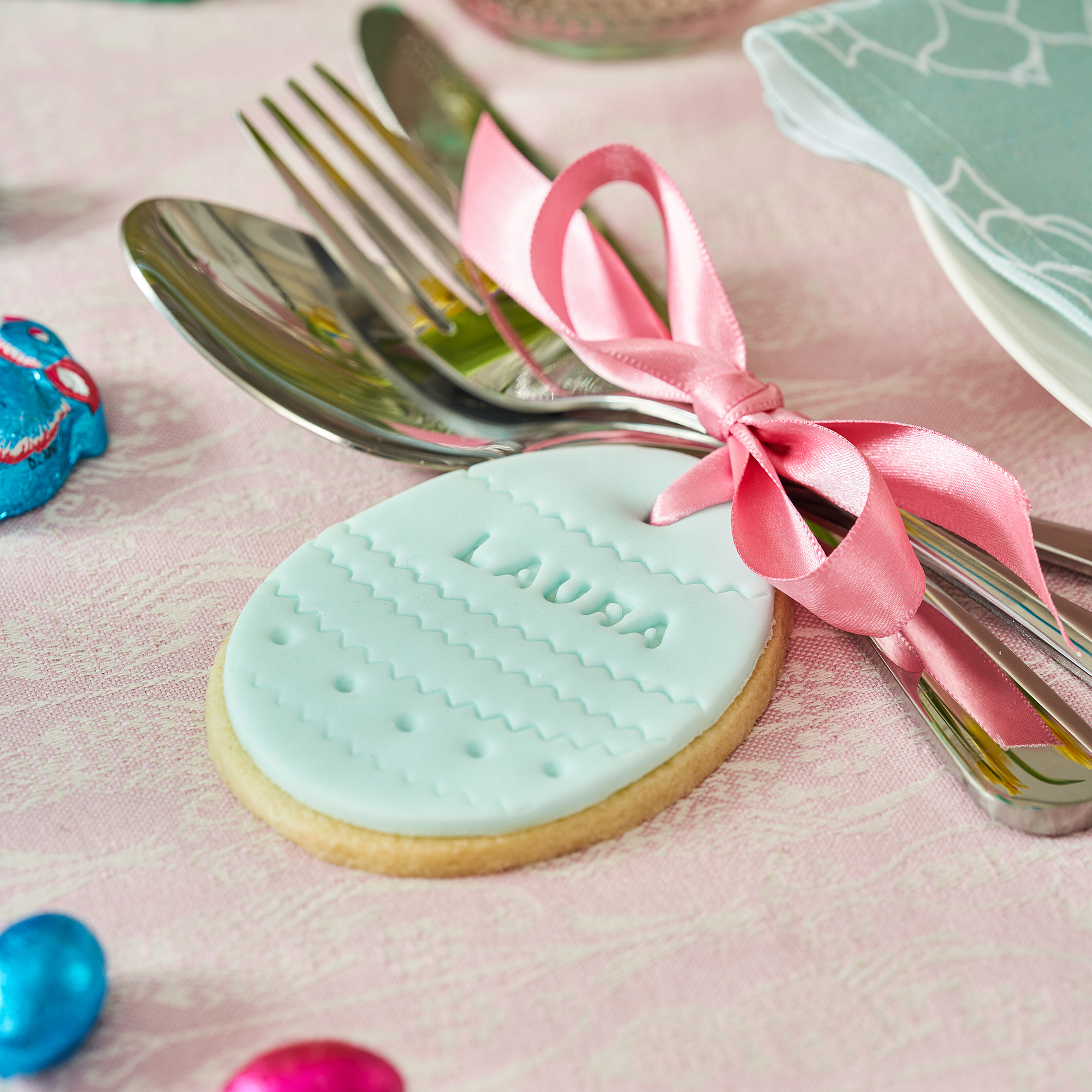 Personalised biscuit used on place setting on a pretty and colourful easter table
