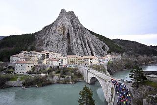 The pack of riders pass the 'Rocher de la Baume' rock formation in Sisteron, during the sixth stage of the Paris-Nice eight days cycling stage race, 198,2km from Sisteron to La Colle-sur-Loup, France, Friday 08 March 2024. BELGA PHOTO JASPER JACOBS (Photo by JASPER JACOBS / BELGA MAG / Belga via AFP)