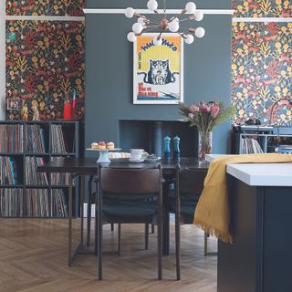 Kitchen with open plan dining room with earth toned wallpaper