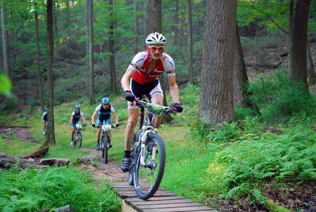 Jeff Schalk (Trek) is being stalked by the Team CF trio through Three Bridges.