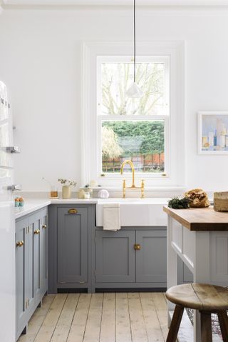 white kitchen with quartz kitchen countertop by deVOL