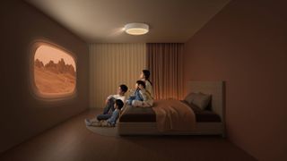 XGIMI Magic Lamp – a ceiling-mounted projector and lamp. A woman and three children sitting on a double bed looking at a wall with a screen being projected onto it from a round lamp on the roof.