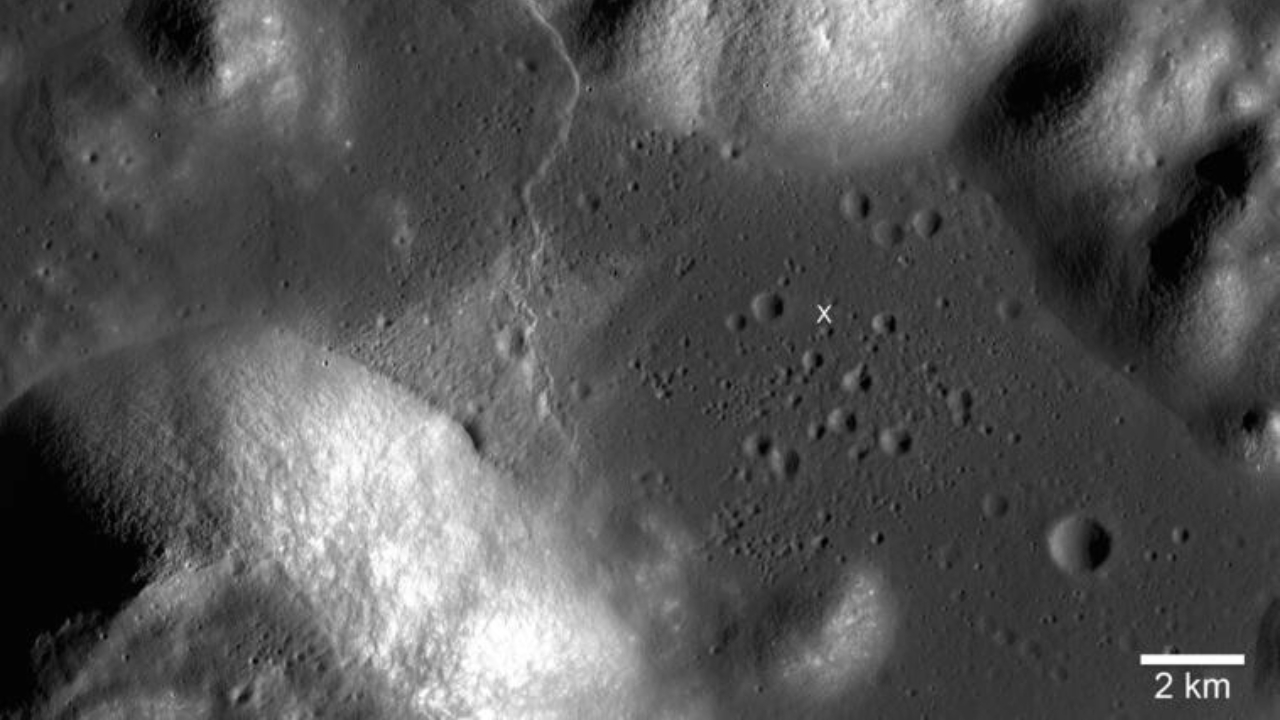 A black and white image showing craters and hills on the moon's surface