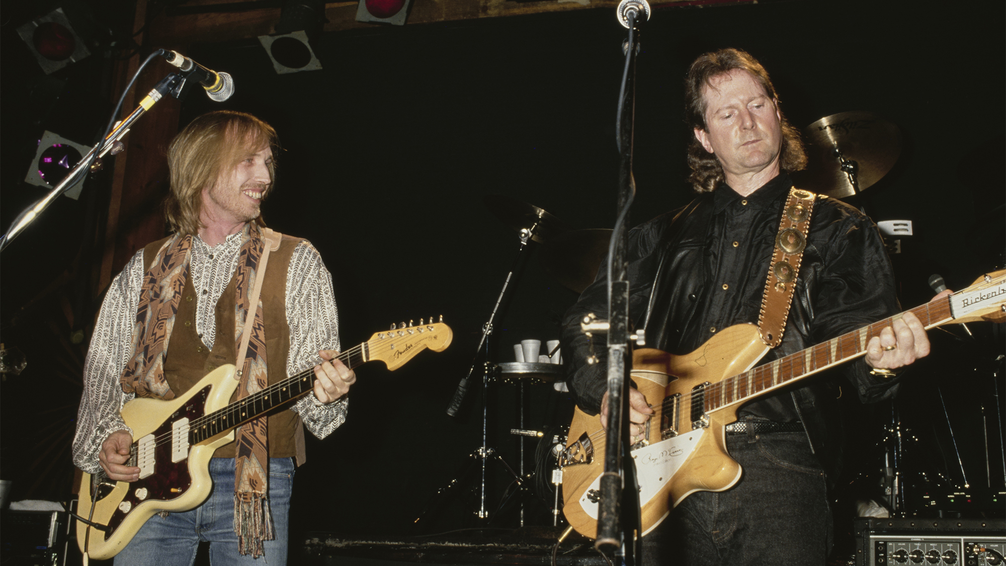 American singer, songwriter and musician Tom Petty (1950-2017) joins American singer and musician Roger McGuinn on stage at the Troubadour, a nightclub in West Hollywood, California, 31st January 1991. The concert is being staged as a showcase for attendees of the Pollack Media Group convention in Los Angeles.