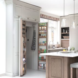 full height fitted pantry in grey kitchen and wooden island