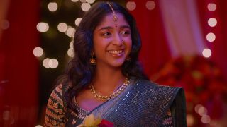  Maitreyi Ramakrishnan smiling as Devi at Pati's wedding in the finale of Never Have I Ever.