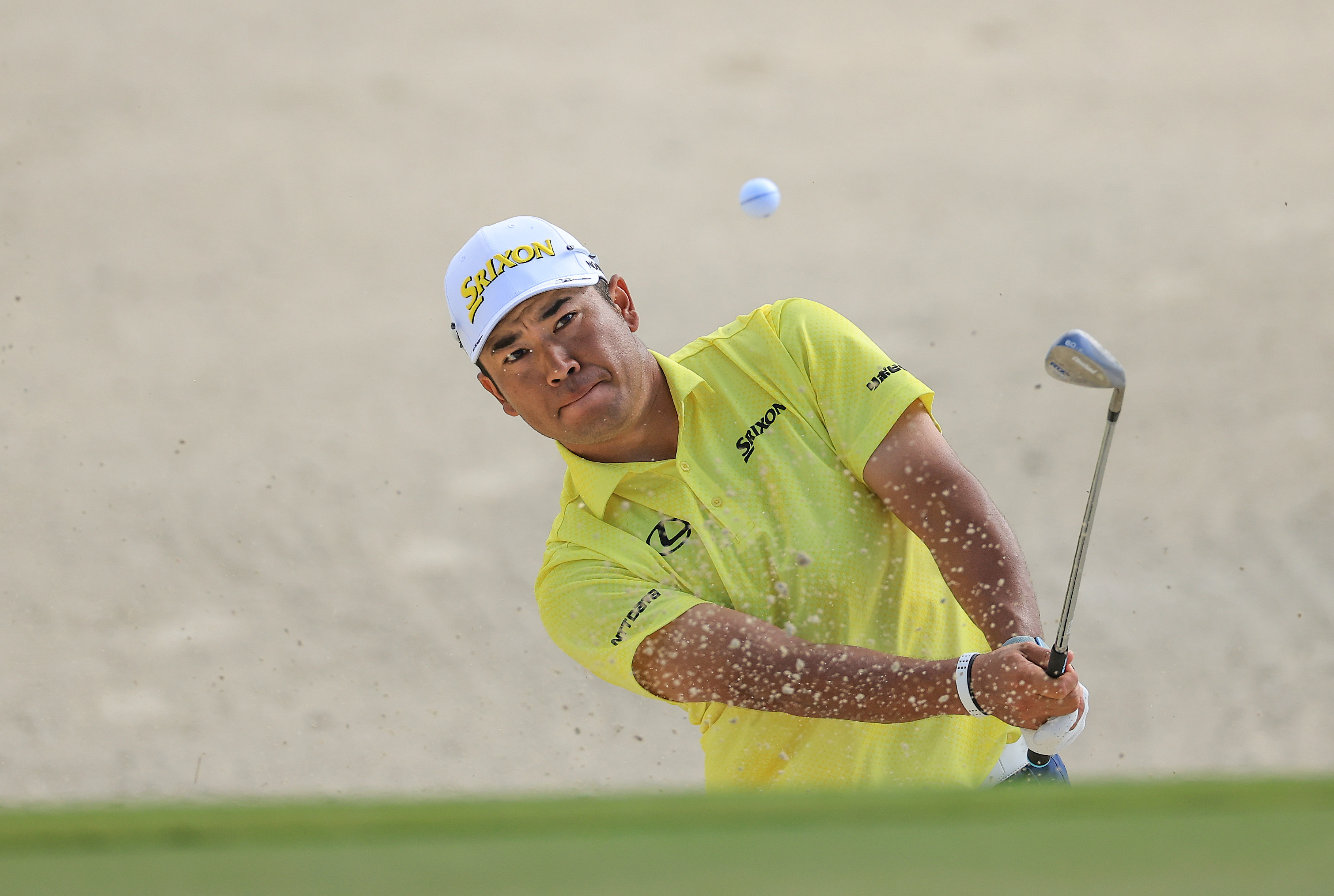 Hideki Matsuyama hits a bunker shot