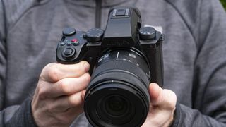 Panasonic Lumix S5 IIX camera in the hand outdoors