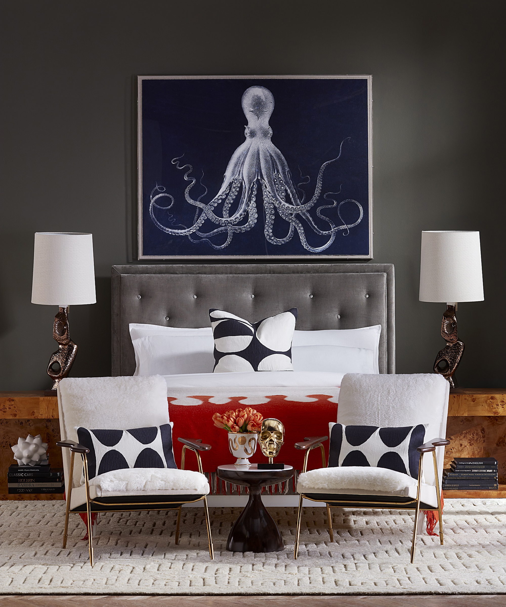 A bedroom color idea with dark grey walls, white armchairs and blue artwork