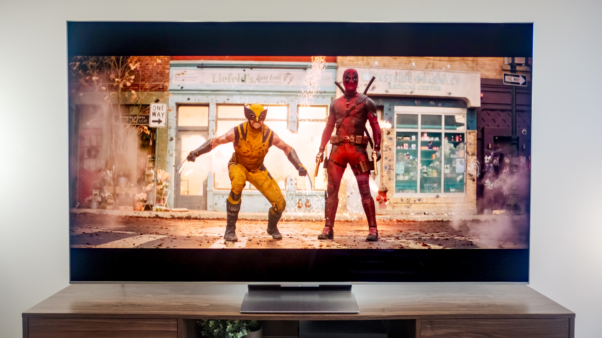 A TCL QM9K TV on a side table