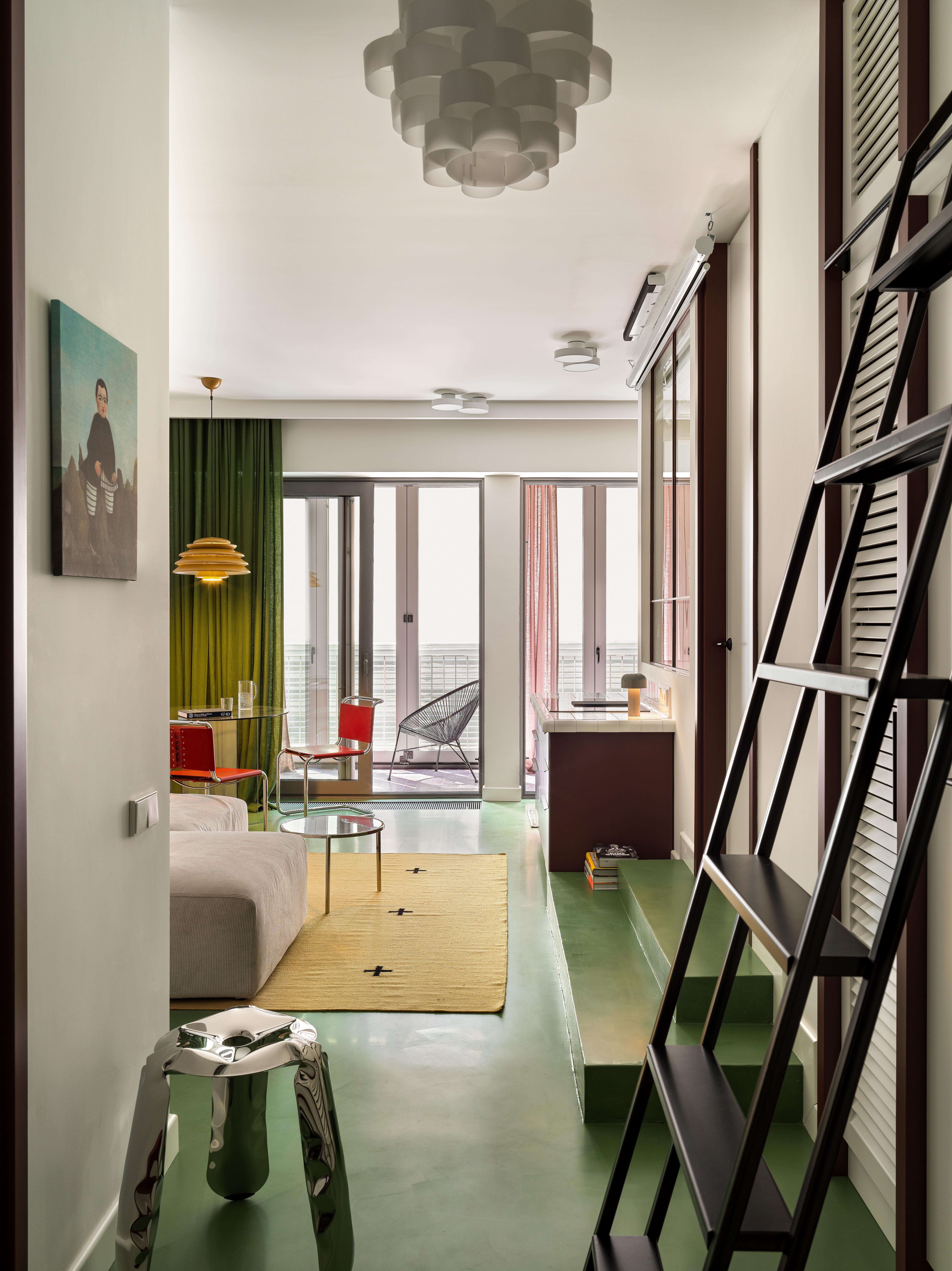 A living room in all green, with a polished, green concrete flooring