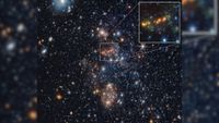 An image of blue and gold and white stars in deep space, with a boxout in the top right corner zooming in on a cluster of golden stars