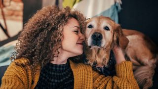 Woman cuddling her dog