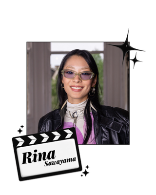 Rina Sawayama smiling in a leather jacket and purple sunglasses