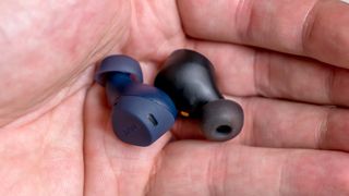 Jabra Elite 7 Pro and 7 Active earbuds loose in hand.