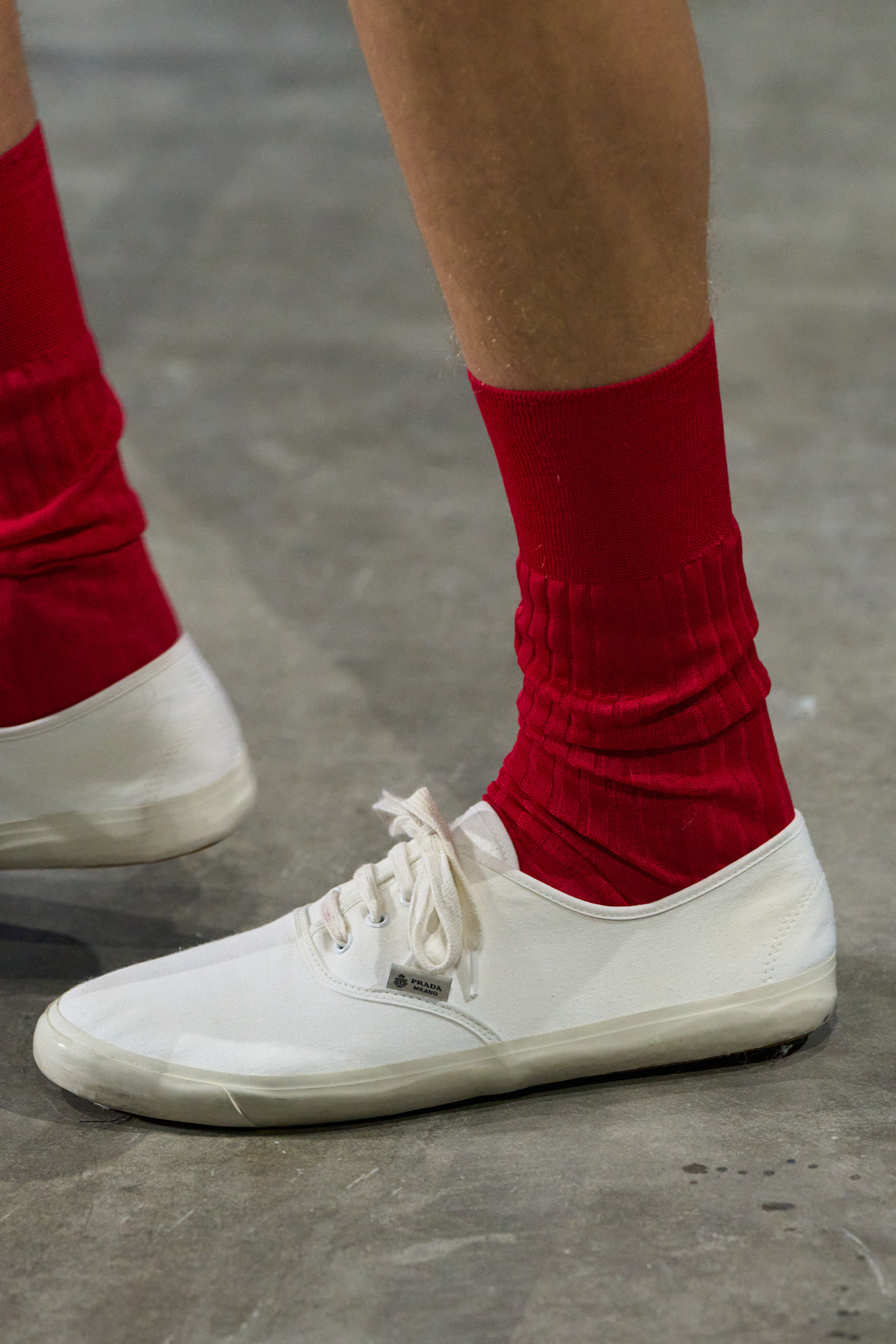 Runway model wearing canvas sneakers, a rising Gen Z sneaker trend.